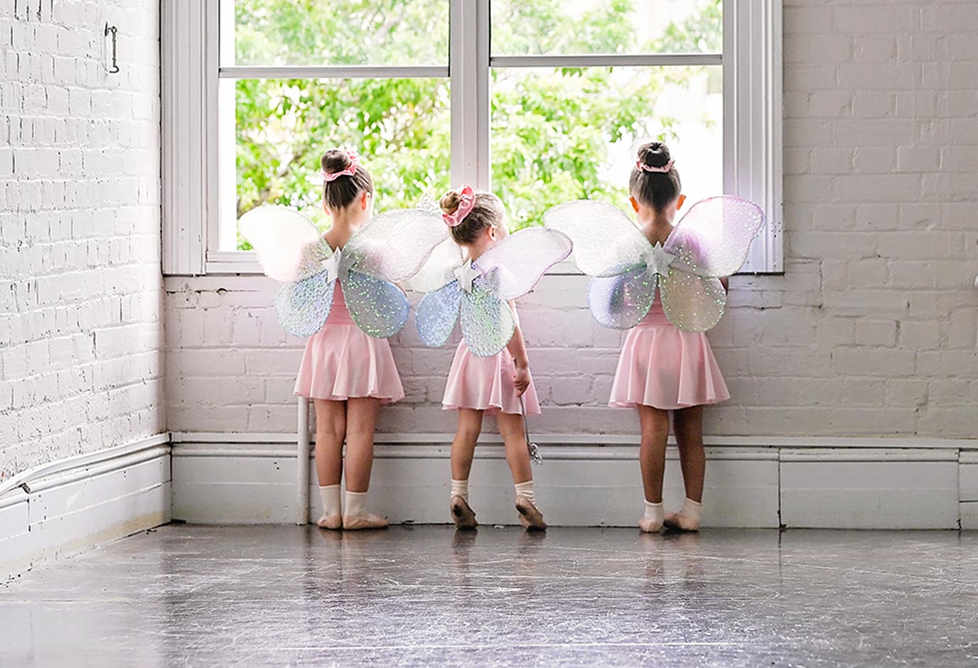 Kinder dancers with fairy wings by the studio window